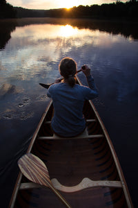 Woman paddling with the Merrimack Canoes Tennessean 14'6" Canoe at the lake