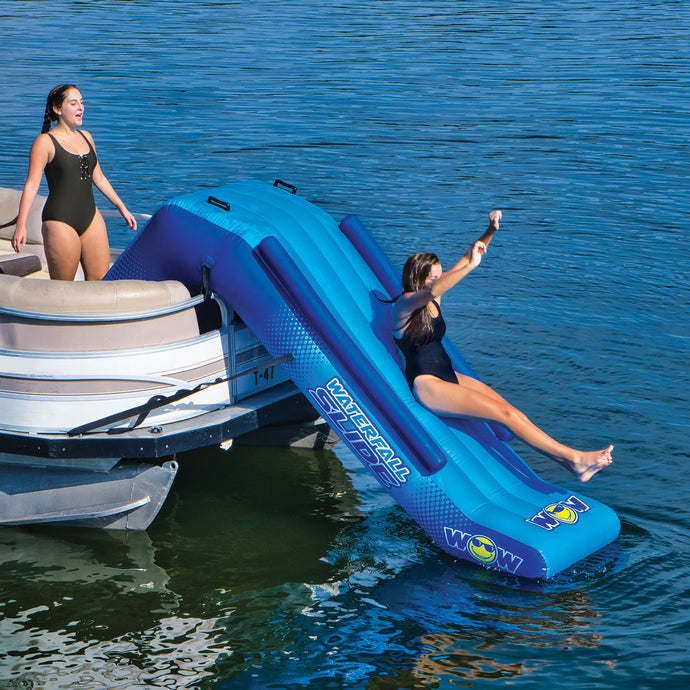 WOW Pontoon Waterfall Slide Inflatable Platform with a women slidding on it and 1 standing beside it