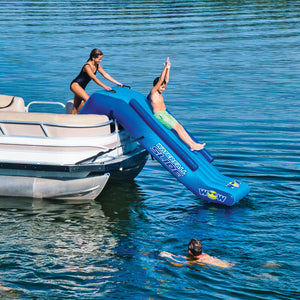 WOW Pontoon Waterfall Slide Inflatable Platform with a women slidding on it and 1 climing on it