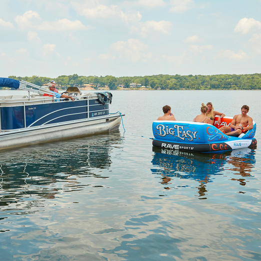 Rave Big Easy 4P Towable Tube floating in the water with 4 peaople sitting on it