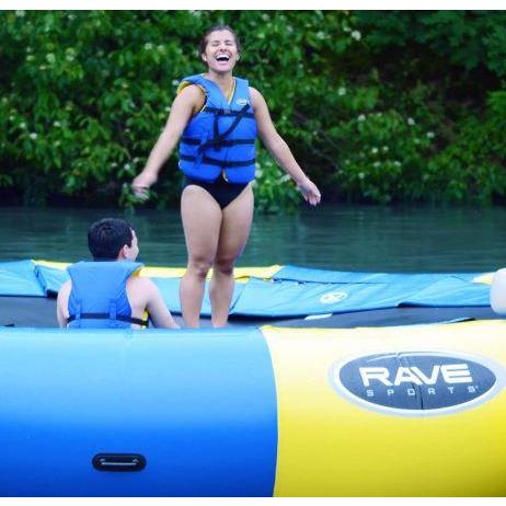 Back of a man and a woman laughing in Rave Sports Aqua Jump 120 Water Trampoline 00120