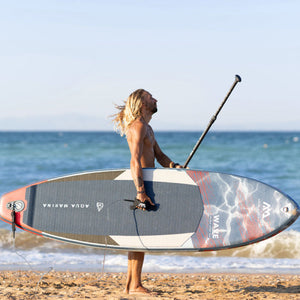 Inflatable Stand Up Paddleboard - Man carrying the Aqua Marina Wave 8'8" Inflatable Stand Up Paddle Board