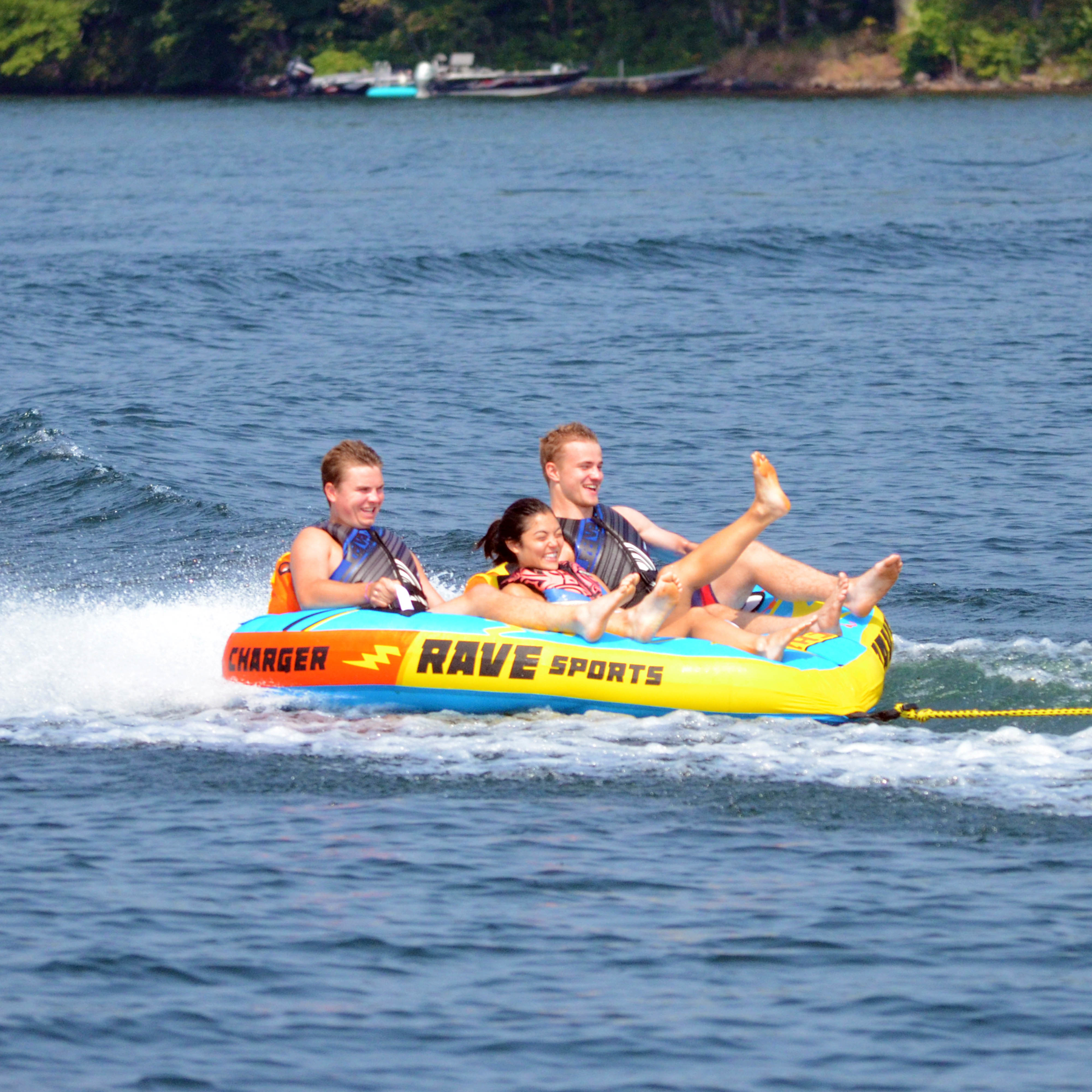 Rave Charger 3P Towable Tube being towed with 3 people riding on it