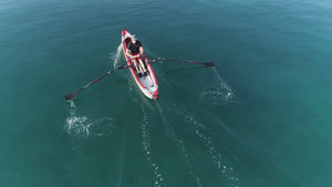 Man rowing on Airkayak16' with ROWONAIR RowMotion Universal Rowing Unit