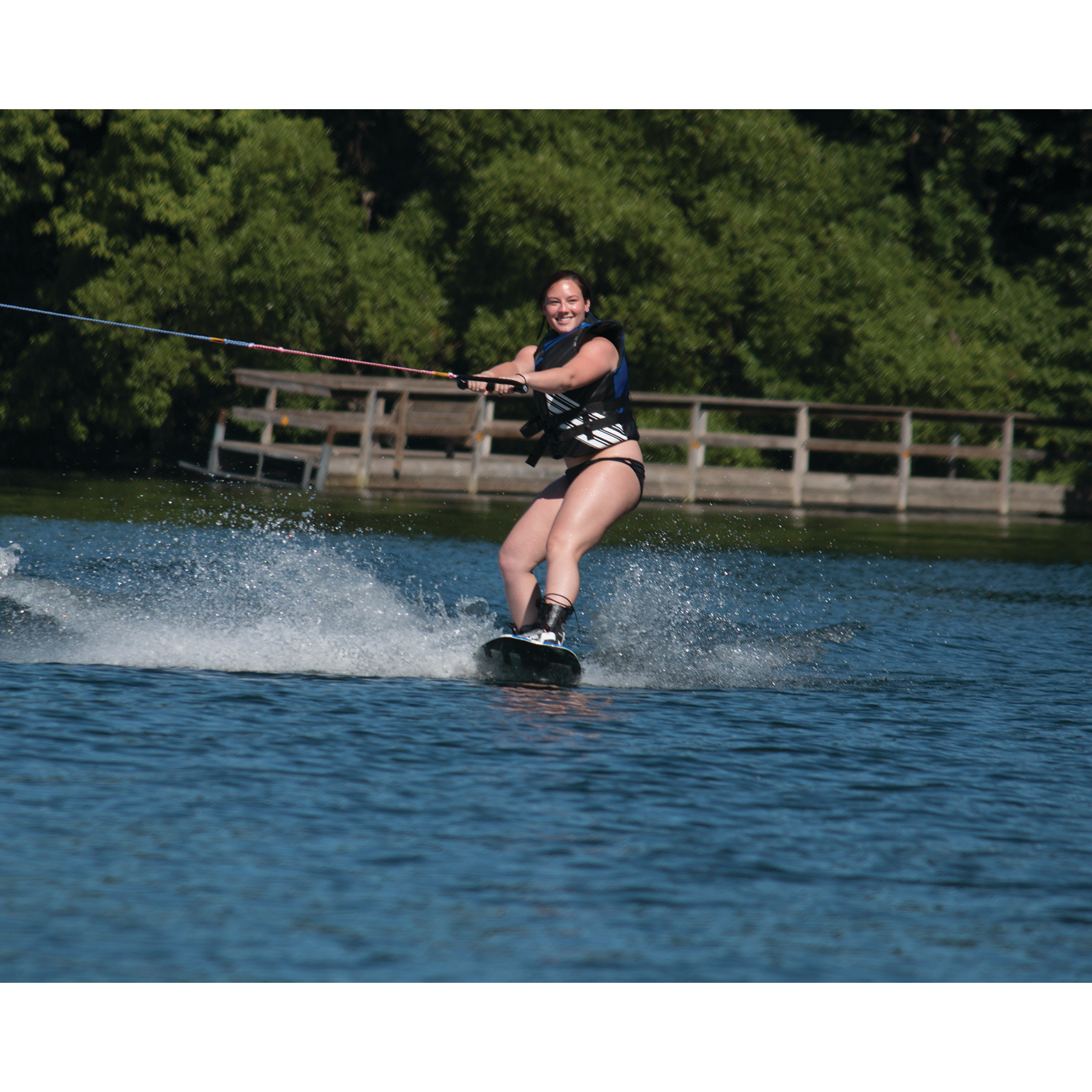 A woman with Rave Freestyle Blue Wakeboard with RAVE boots