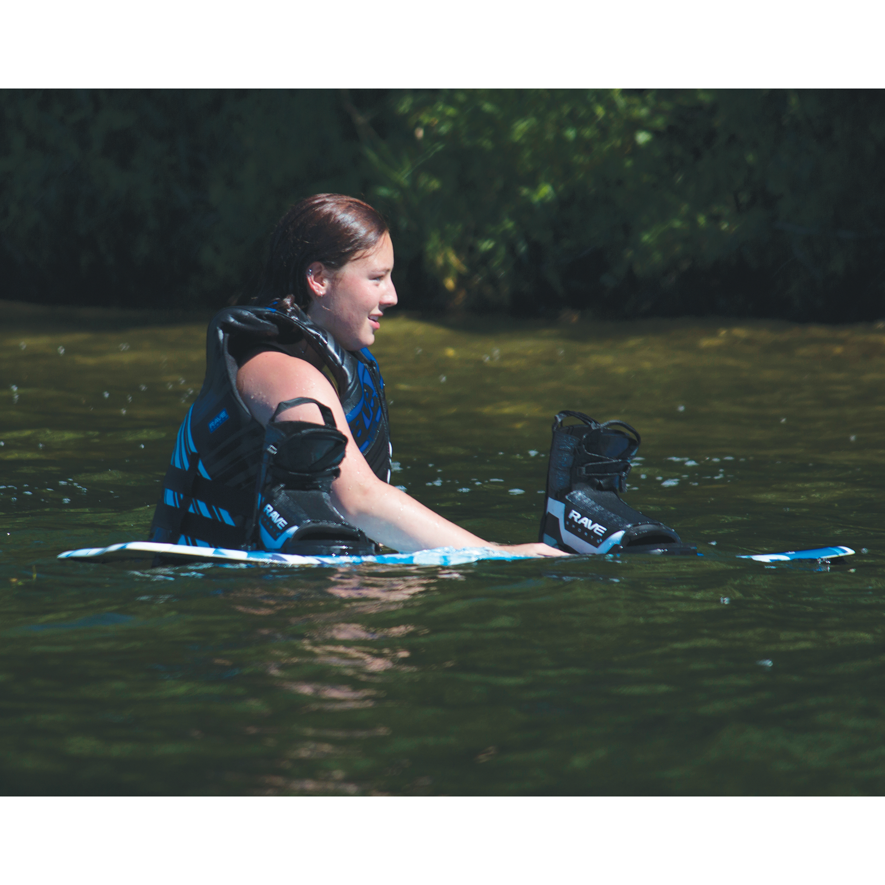 A woman with Rave Freestyle Blue Wakeboard with RAVE boots
