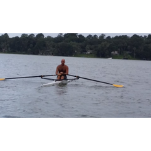 Load image into Gallery viewer, Boats -Man rowing on Little River Marine Olympus Rowing Shell on a quite calm water.