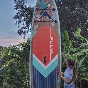 A Girl Showing the back side of Pulse The Honey 10'6" Inflatable Stand Up Paddleboard 