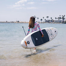 Load image into Gallery viewer, Inflatable Stand Up Paddle Board - woman carrying the Hurley Advantage 10&#39; ISUP Terrazzo HUR-005 