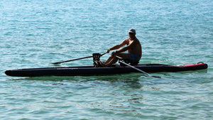 Man rowing on the ROWONAIR iCoaster 18' Inflatable Rowing Board
