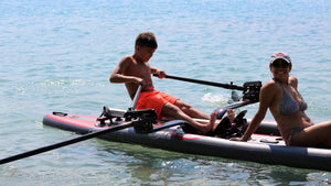 young adult rowing on the ROWONAIR iCoaster 18' Inflatable Rowing Board with passenger