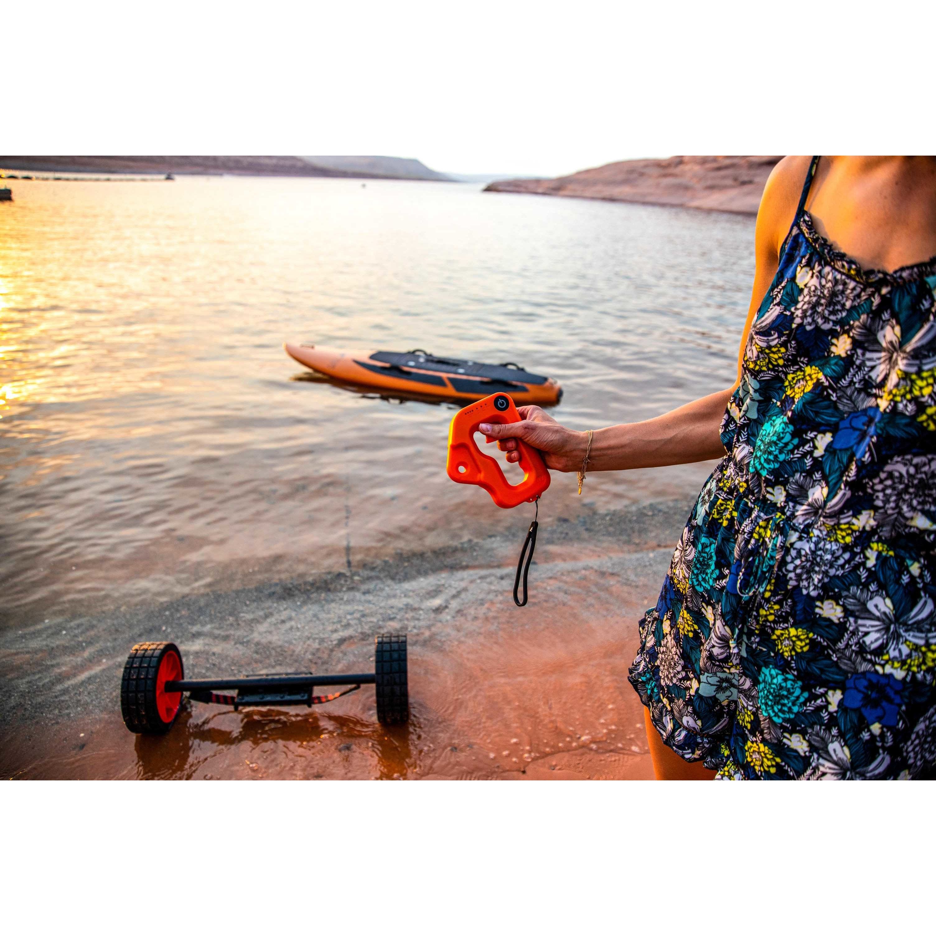 Woman holding Yujet wireless remote with the background of Yujet Surfer Electric Jetboard EJB-01 floating 