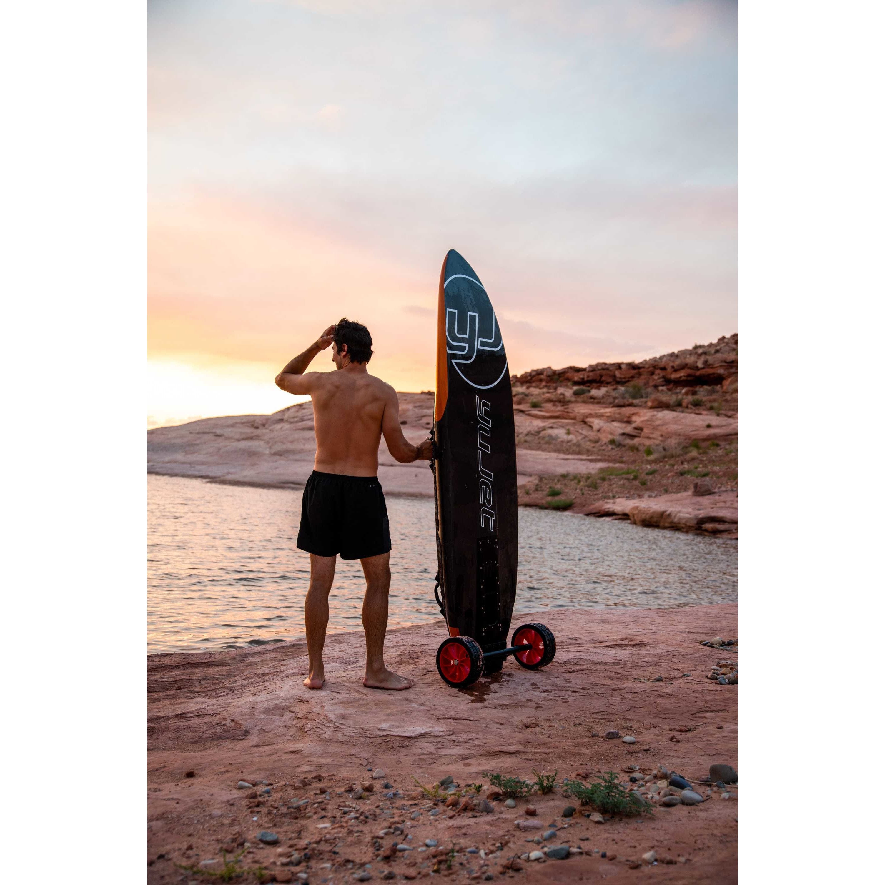 Back of view of a man holding Yujet Surfer Electric Jetboard EJB-01 with wheels