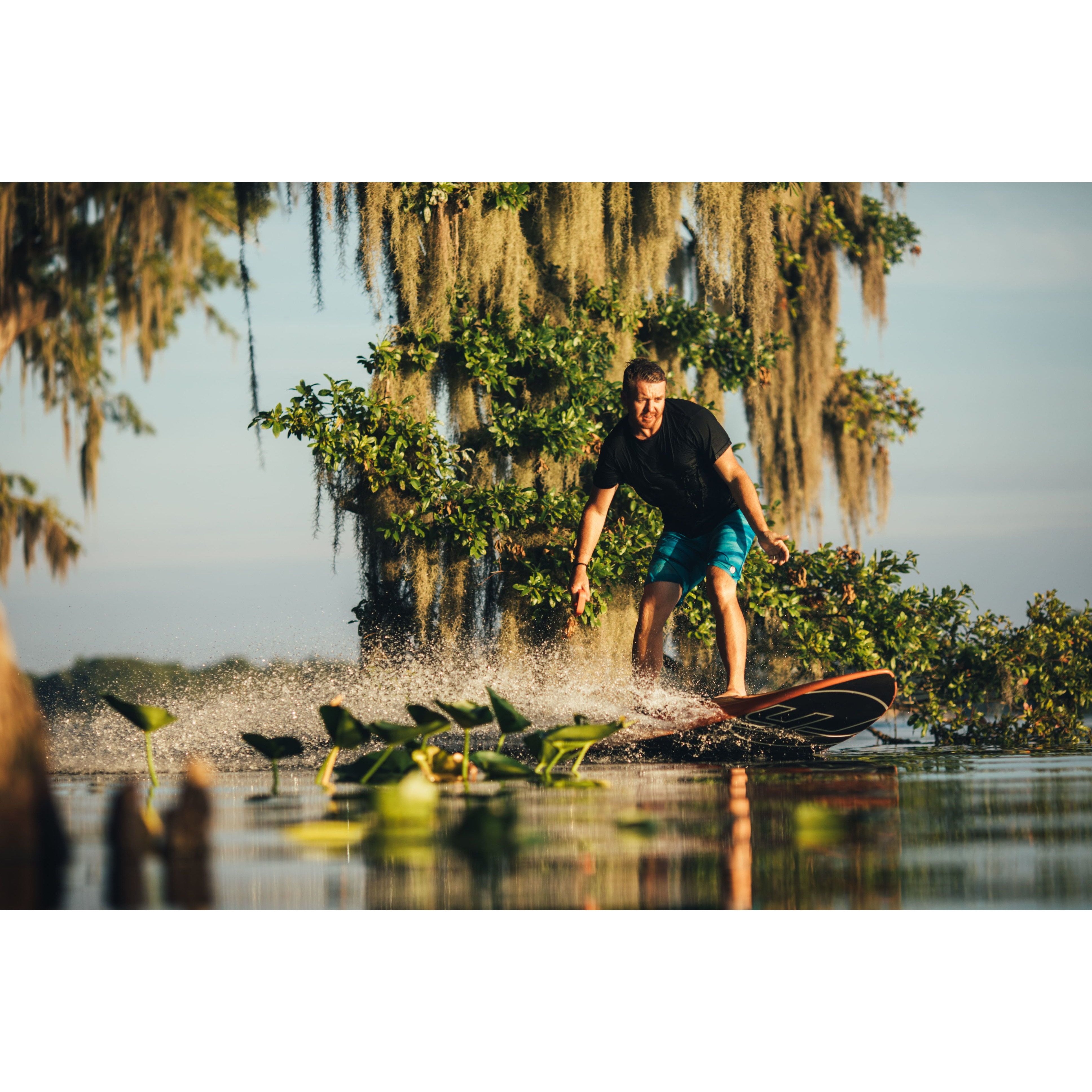 Man in a black shirt riding Yujet Electric Surfobard EJB-01 