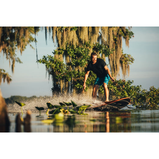 Man in a black shirt riding Yujet Electric Surfobard EJB-01 