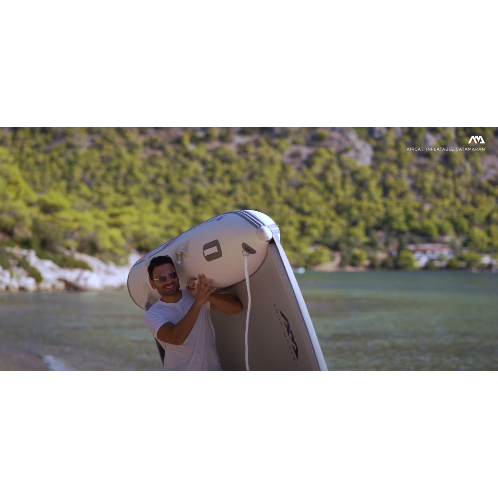 Boat - Man carrying the Aqua Marina The Aircat Catamaran BT-AC335 