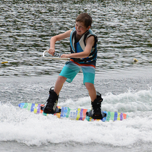 Load image into Gallery viewer, A kid wakeboarding with Wakeboard Starter Package Impact Brick