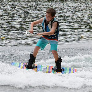 A kid wakeboarding with Wakeboard Starter Package Impact Brick