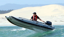 Load image into Gallery viewer, Man riding the Takacat T260LX Inflatable Boat