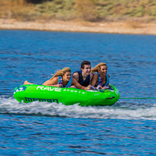 Load image into Gallery viewer, Rave Mambo Navy Camo 3P Towable Tube being towed with 3 people riding on it