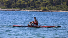 Load image into Gallery viewer, Man rowing on the ROWONAIR Mojo 18&#39; Inflatable Paddle Board with RowOnAir Universal Rowing Unit