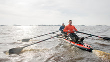 Load image into Gallery viewer, Man and woman tandem rowing on the ROWONAIR Mojo 18&#39; Inflatable Paddle Board with RowOnAir Universal Rowing Unit