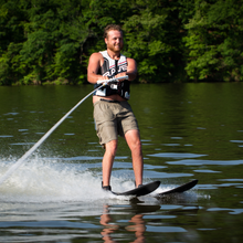 Load image into Gallery viewer, A Man Skiing the Rave Adult Rhyme Shaped Combo Water Ski