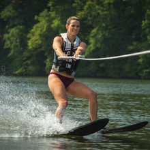 Load image into Gallery viewer, A woman skiing the Rave Adult Rhyme Shaped Combo Water Ski