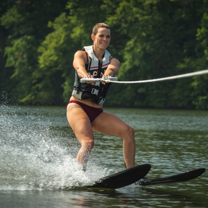 A woman skiing the Rave Adult Rhyme Shaped Combo Water Ski