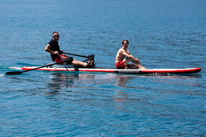 Man rowing with the ROWONAIR Dude 18' Inflatable Paddle Board with passenger