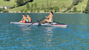 Woman rowing on iCoaster 18' with the ROWONAIR RowVista Universal Rowing Unit