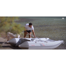 Load image into Gallery viewer, Boat - MAn with a dog setting up the Aqua Marina The Aircat Catamaran BT-AC335 on the  shore