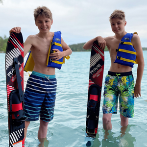2 teen boys standing and holding Rave Shredder Combo Water Skis
