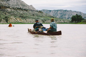 Men with some stuffs loaded in the Merrimack Canoes Souhegan - 16' Canoe