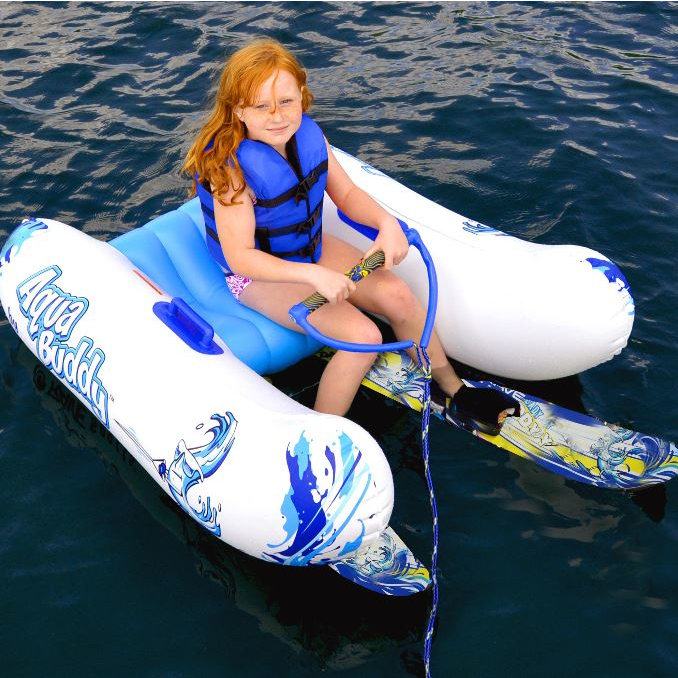 A kid riding in Rave Aqua Buddy while getting ready to ski with Rave Steady Eddy Trainer Water Ski'