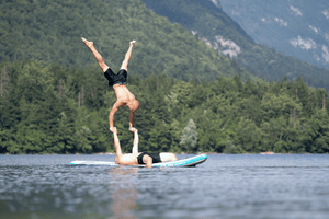 Two Men Performing Acrobatics On A SipaBoards Inflatable Paddleboards