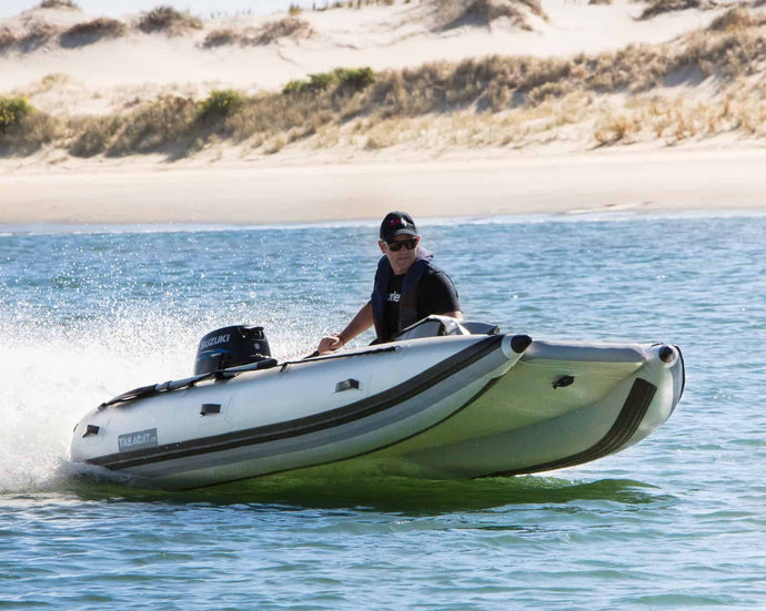 Man riding the Takacat T300LX Inflatable Boat