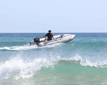 Load image into Gallery viewer, Man riding the Takacat T340LX Inflatable Boat