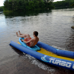 Man riding the turbo water sled on to the lake from the Rave Sports 116' Turbo Chute Package 02971-12