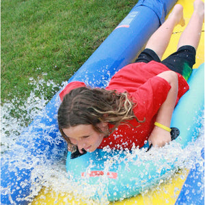 Kid riding the turbo water sled sliding in  the Rave Sports 116' Turbo Chute Package 02971-12